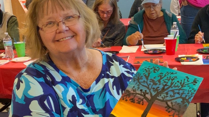 Chandler golden neighbor holding a DIY painting Chandler golden neighbor holding a DIY painting